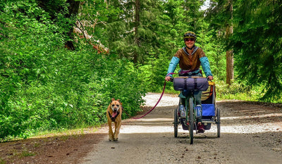 Laura and her dog mountain biking together